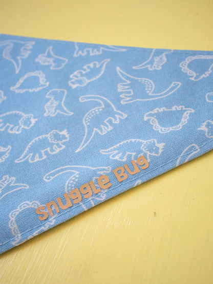 Blue bandana with white dinosaur patterns and 'Snuggle Bug' text on a yellow background