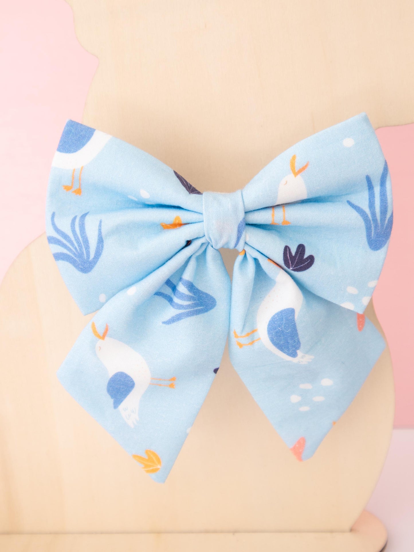 Large blue bow with animal pattern on a beige background