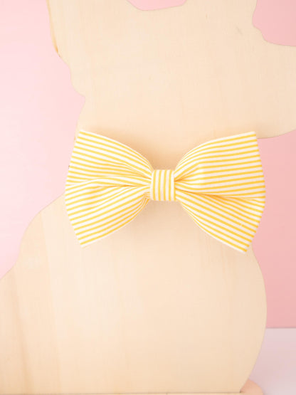 Yellow bow on a pink and beige background