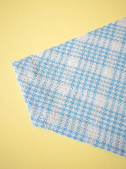 Blue and white checkered fabric on a yellow background