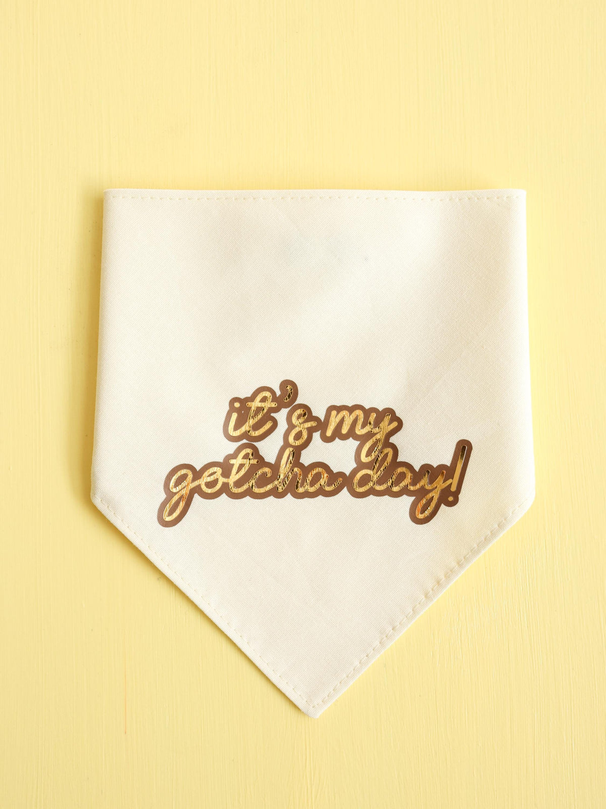 Cream/Beige snap on dog bandana with 'it's my gotcha day!' text on a yellow background
