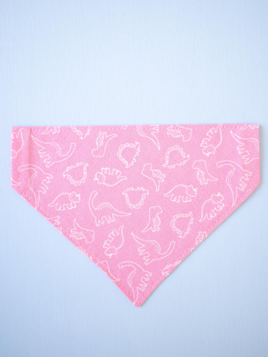 Pink bandana with white dinosaur pattern on a light blue background