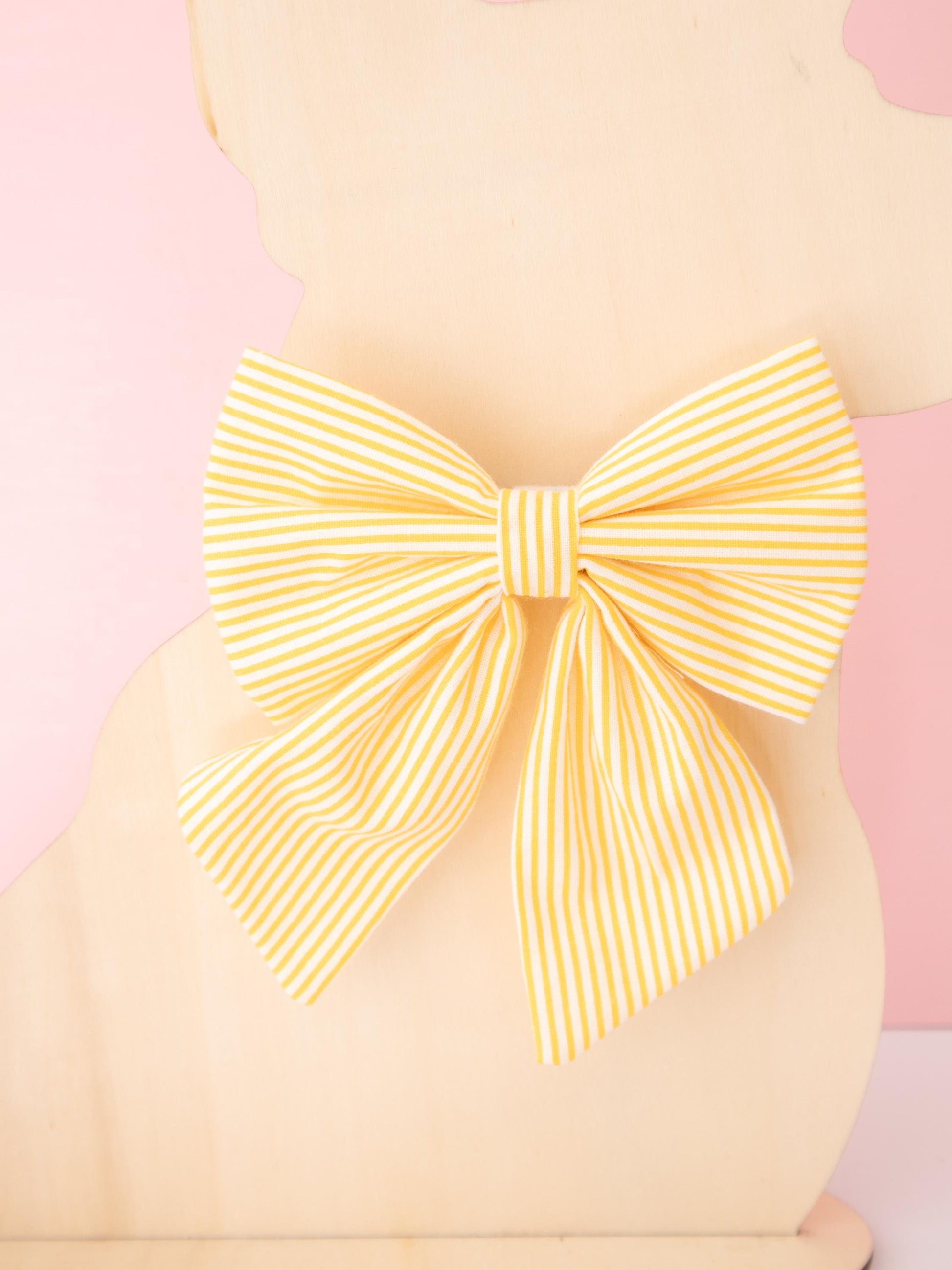 Large yellow bow on a pink background