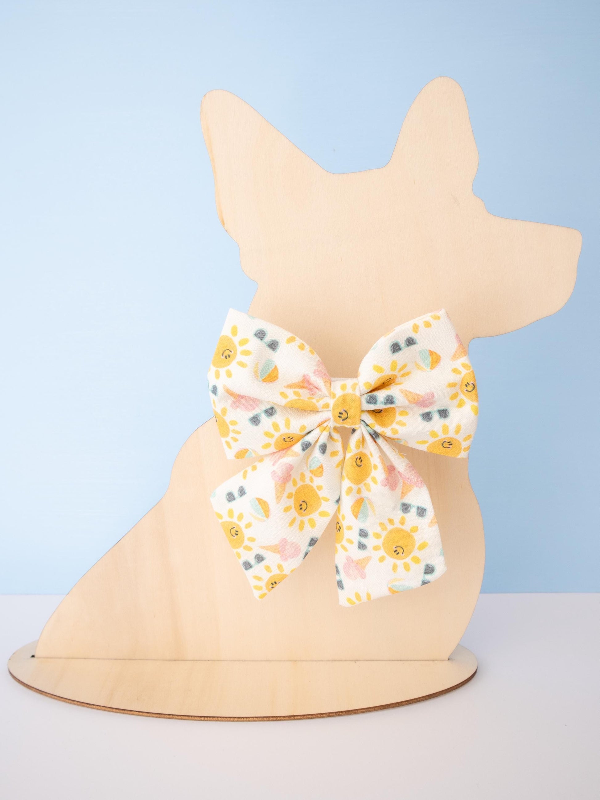 Patterned bow on a mannequin head against a light blue background