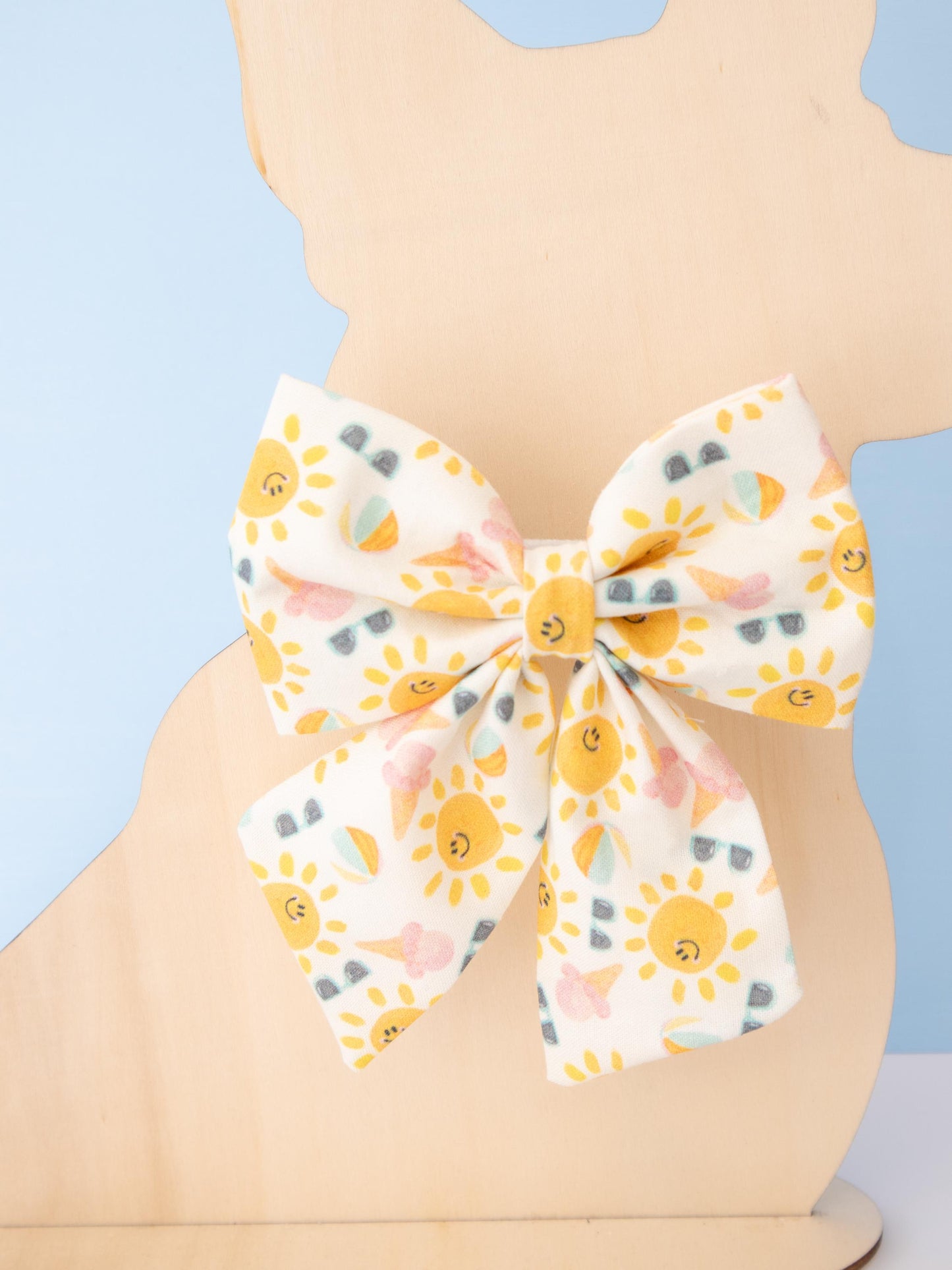 Bow tie with sun pattern on a light blue background