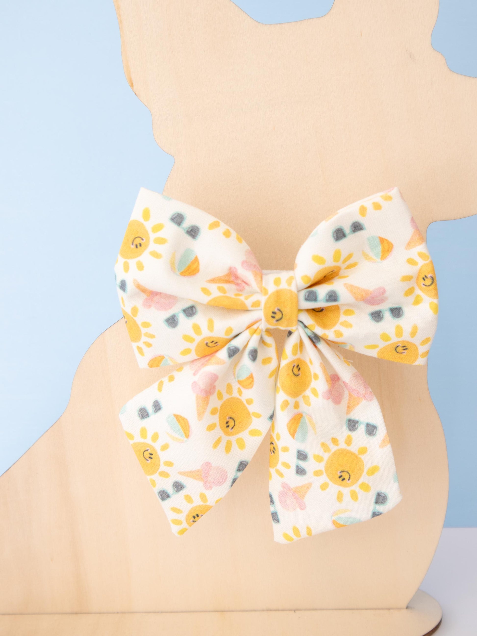 Bow tie with sun pattern on a light blue background