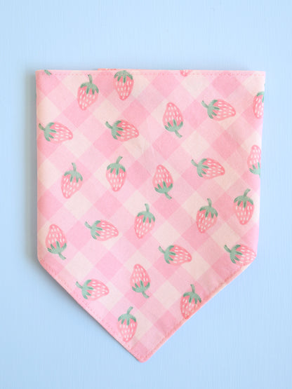 Pink bandana with strawberry pattern on a light blue background