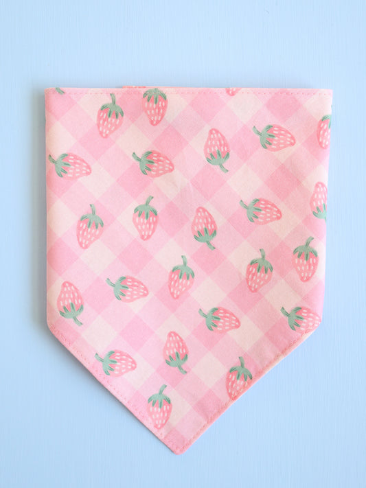 Pink bandana with strawberry pattern on a light blue background