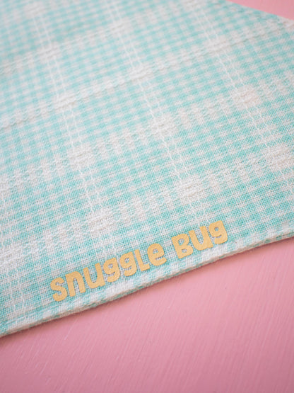 Bandana with 'snuggle bug' text on a pink background