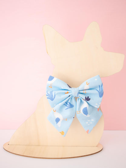 Dog model with a blue bow on a pink background