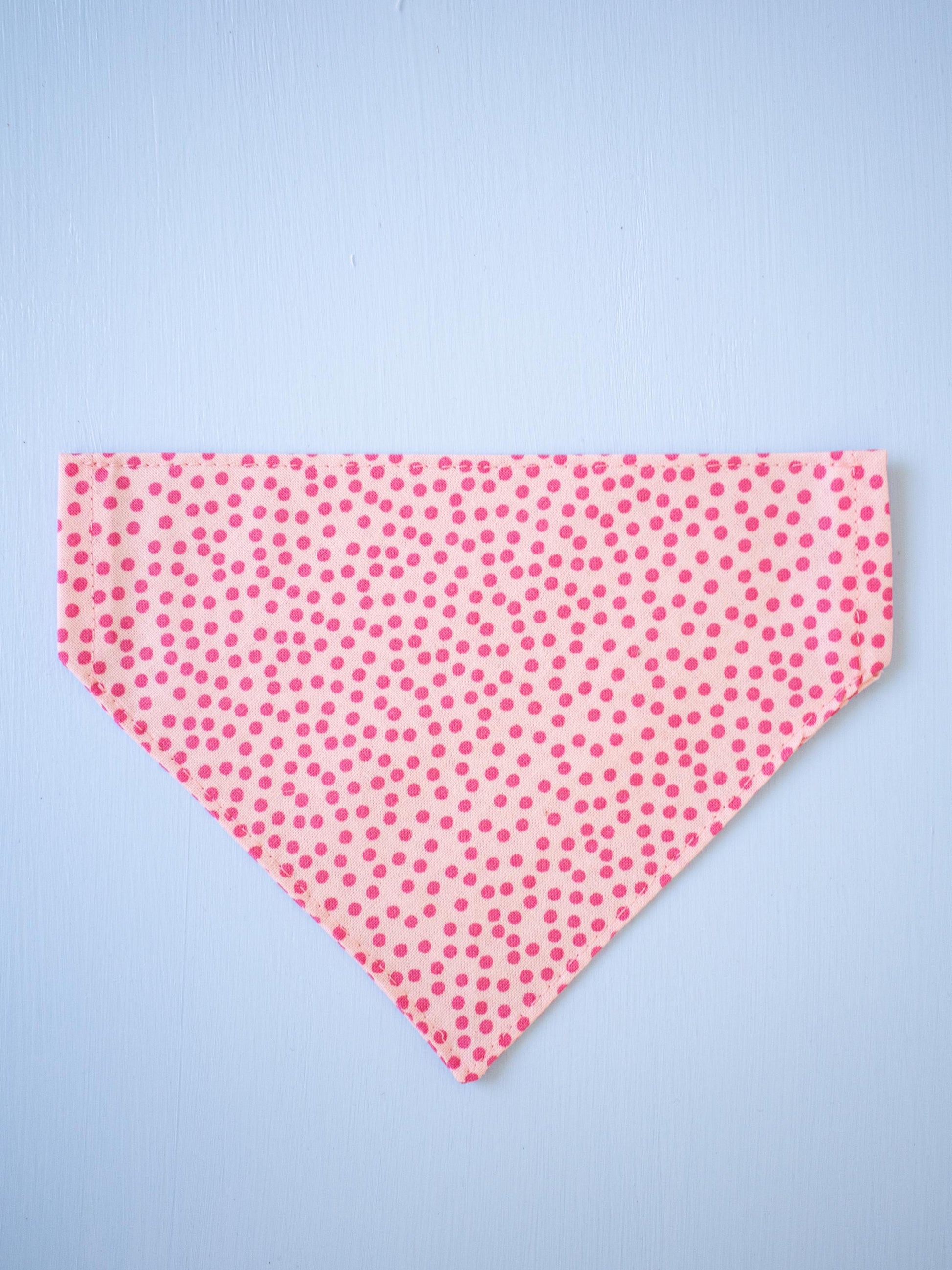 Pink polka dot bandana on a light blue background