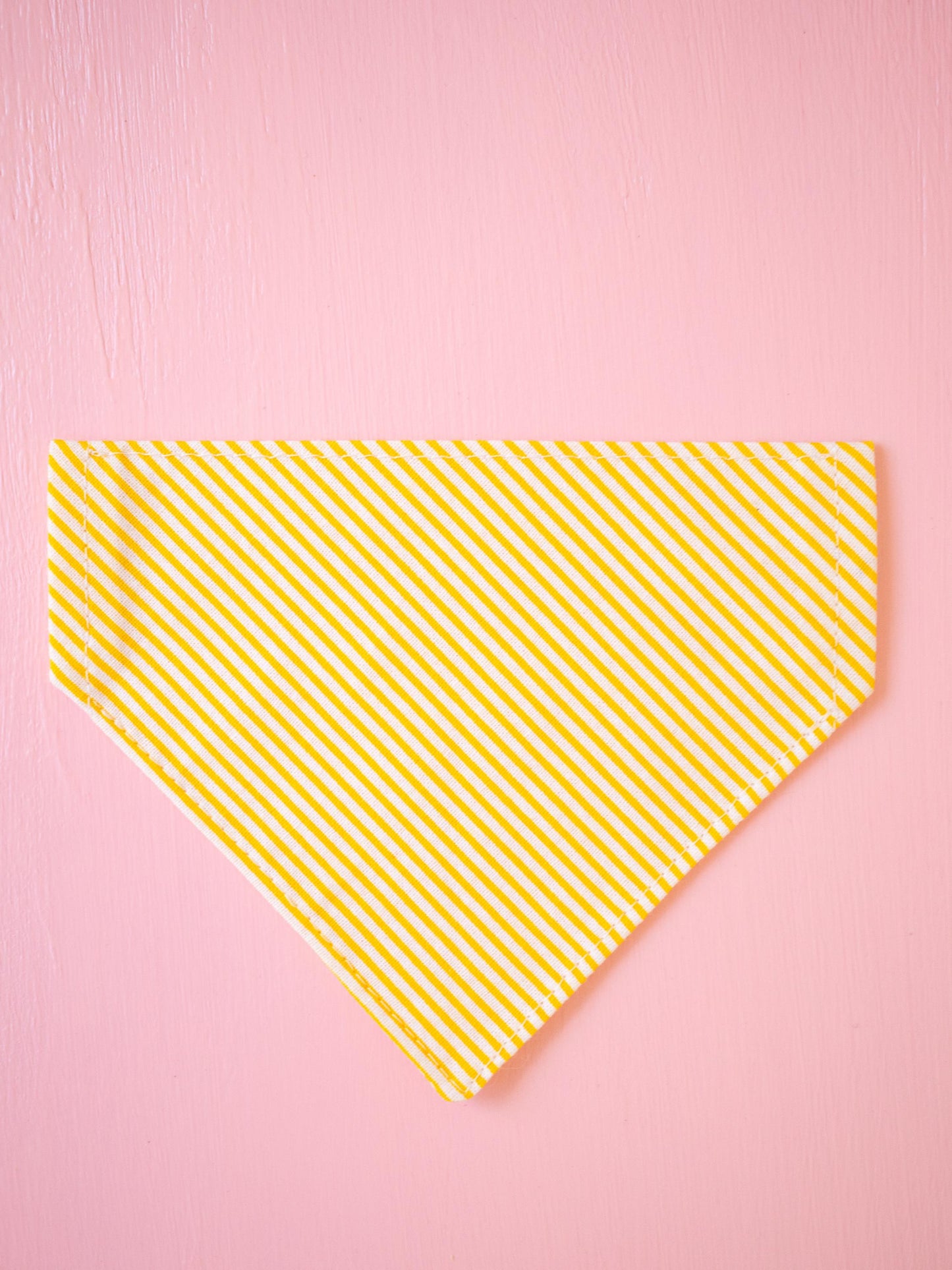 Yellow striped bandana on a pink background