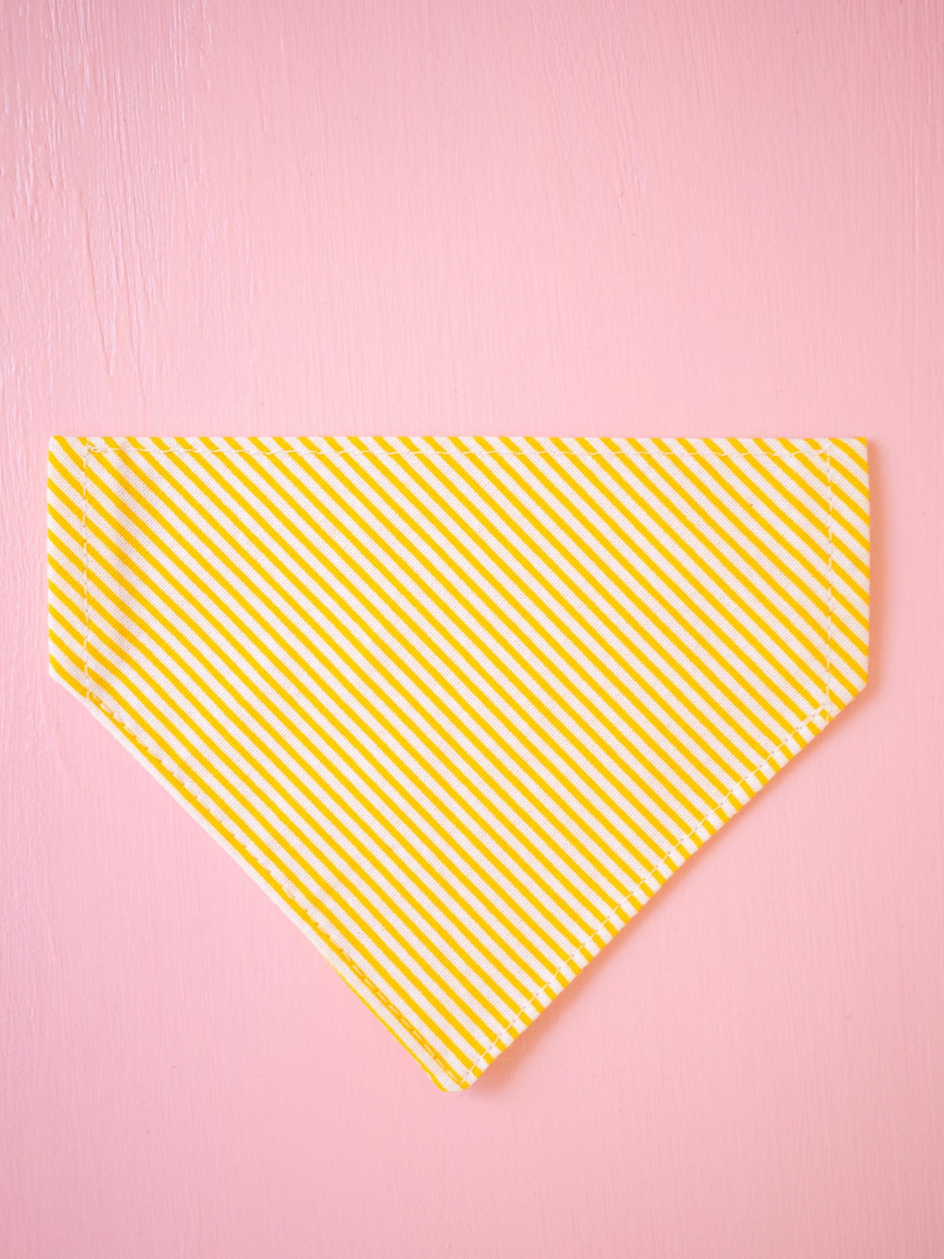 Yellow striped bandana on a pink background