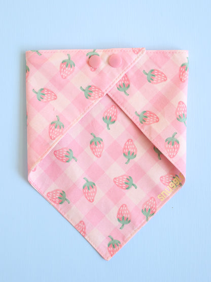 Pink bandana with strawberry pattern on a light blue background