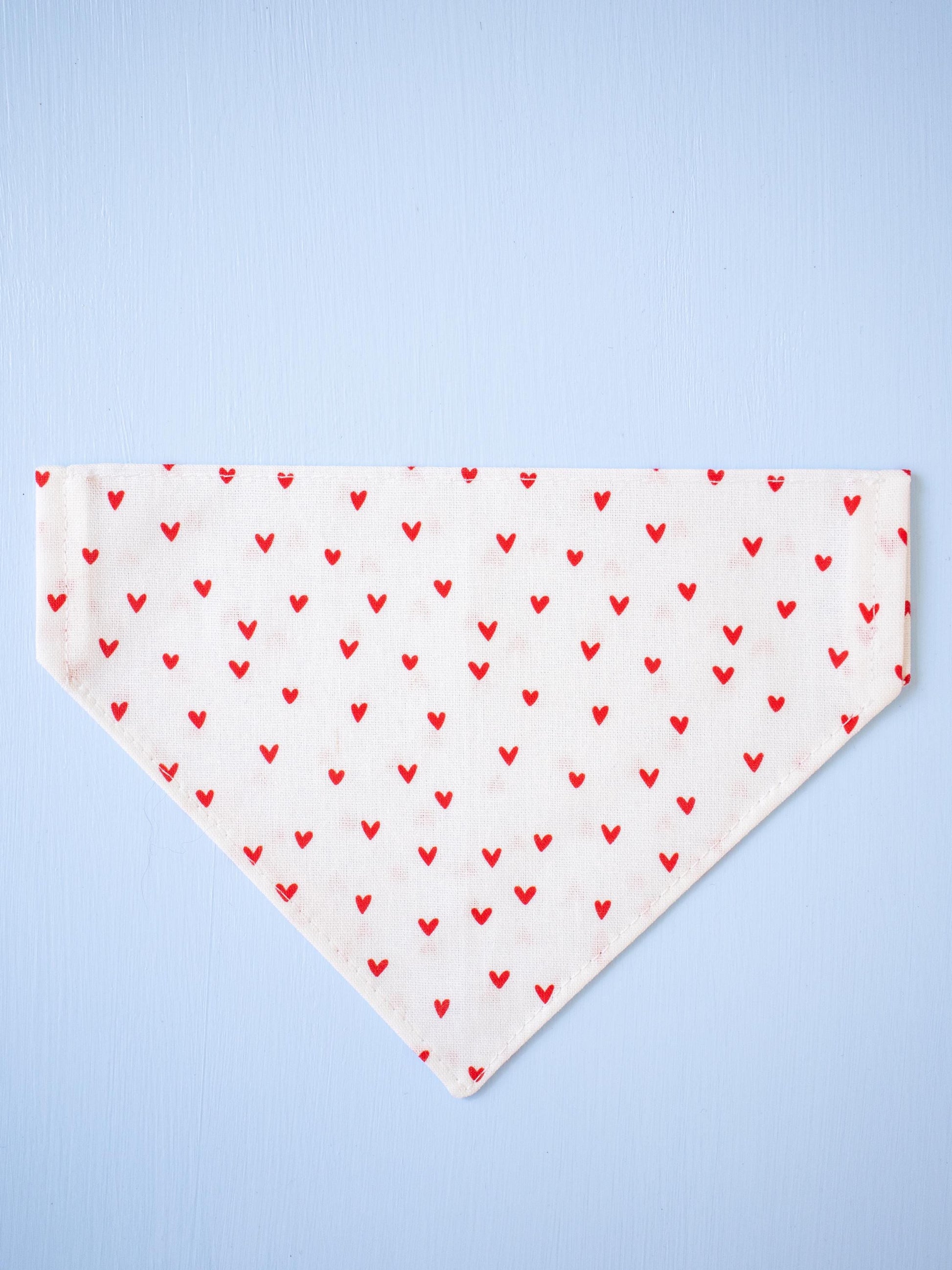 White Dog bandana with red heart pattern on a light blue background