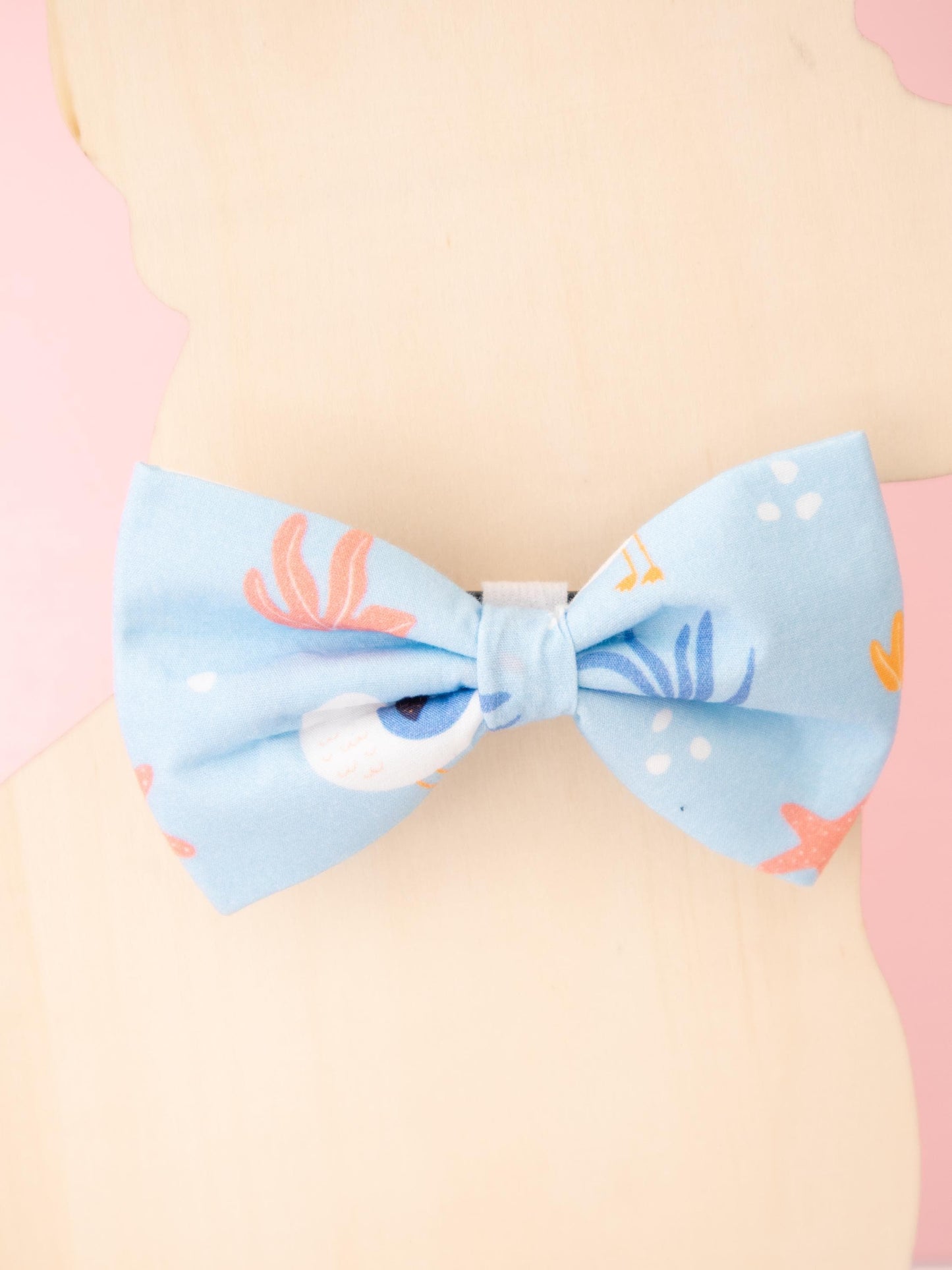 Light blue bow on a pastel background