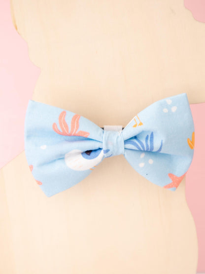 Light blue bow on a pastel background