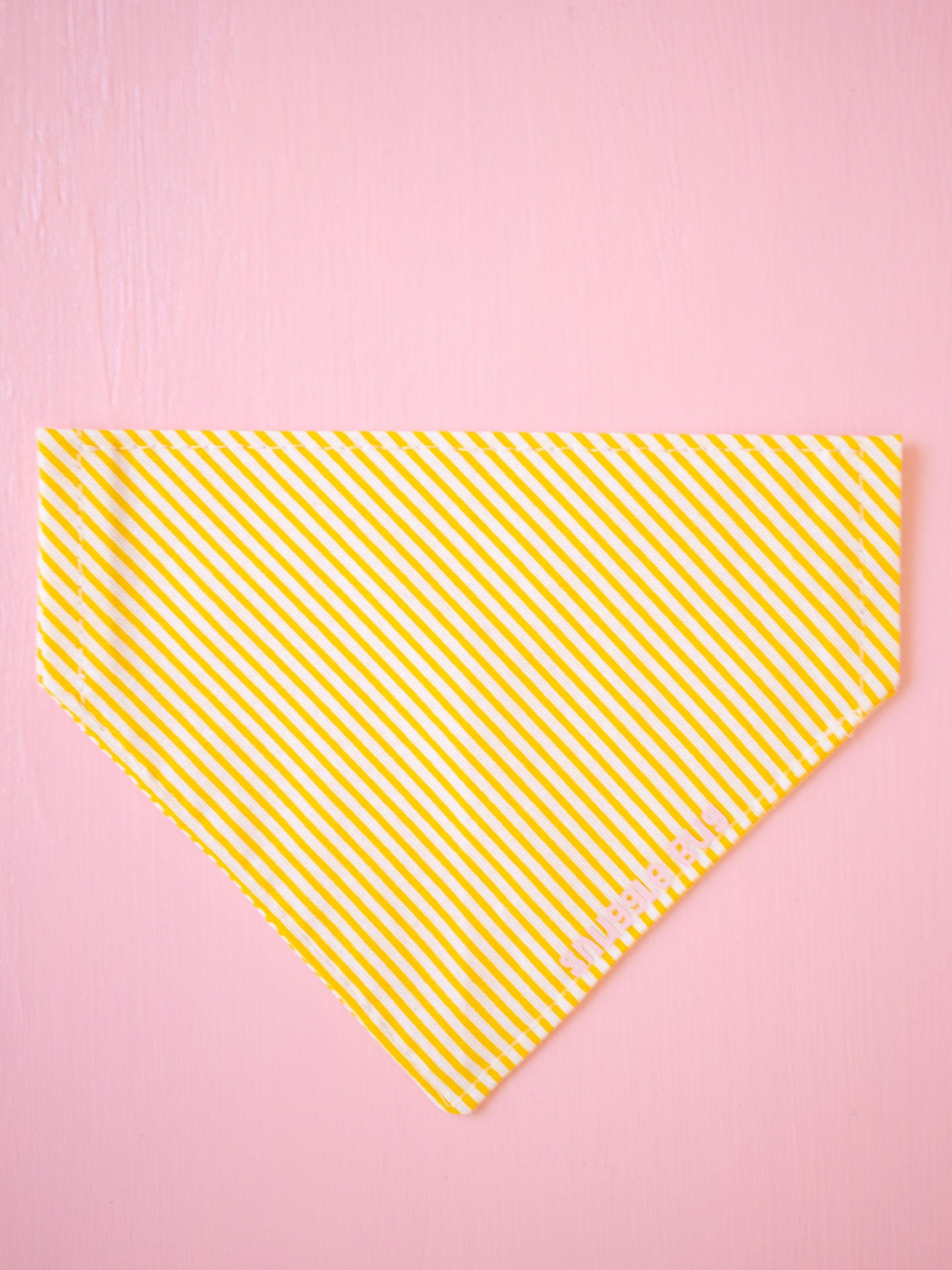 Yellow striped bandana on a pink background