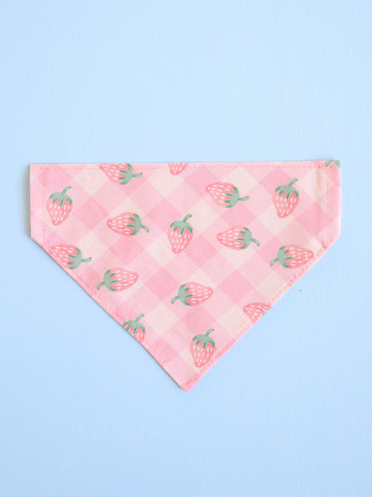 Pink bandana with strawberry pattern on a light blue background