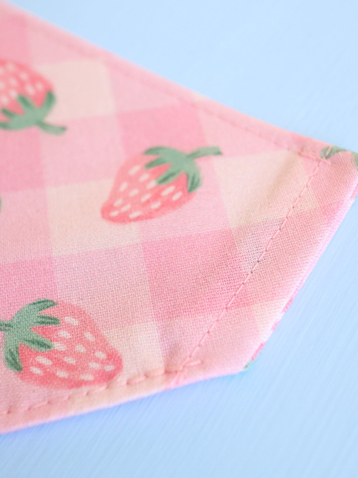 Fabric with strawberry pattern on a light blue background