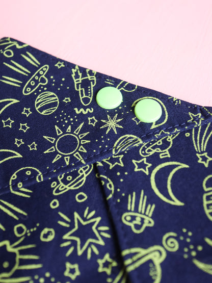 Navy blue fabric with green space-themed patterns on a pink background
