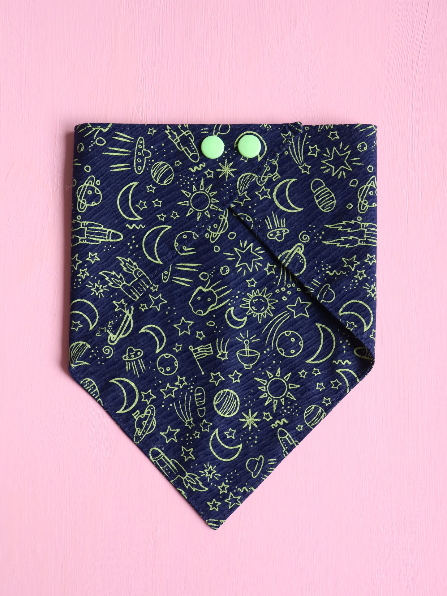 Navy blue bandana with green celestial pattern on a pink background