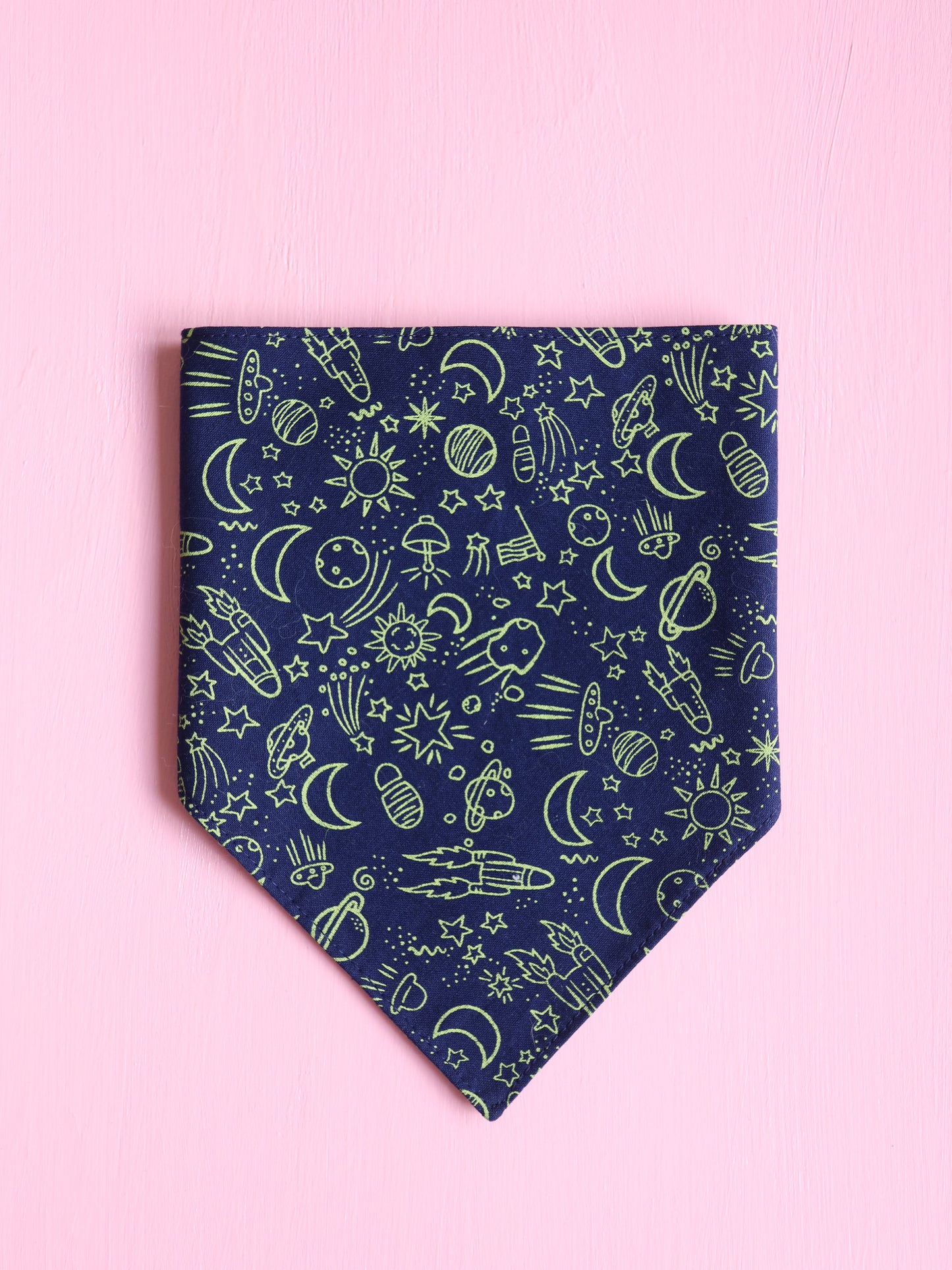 Navy blue bandana with green space themed pattern on a pink background