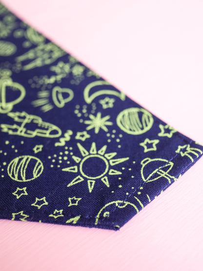 Navy blue fabric with green space-themed pattern on a pink background