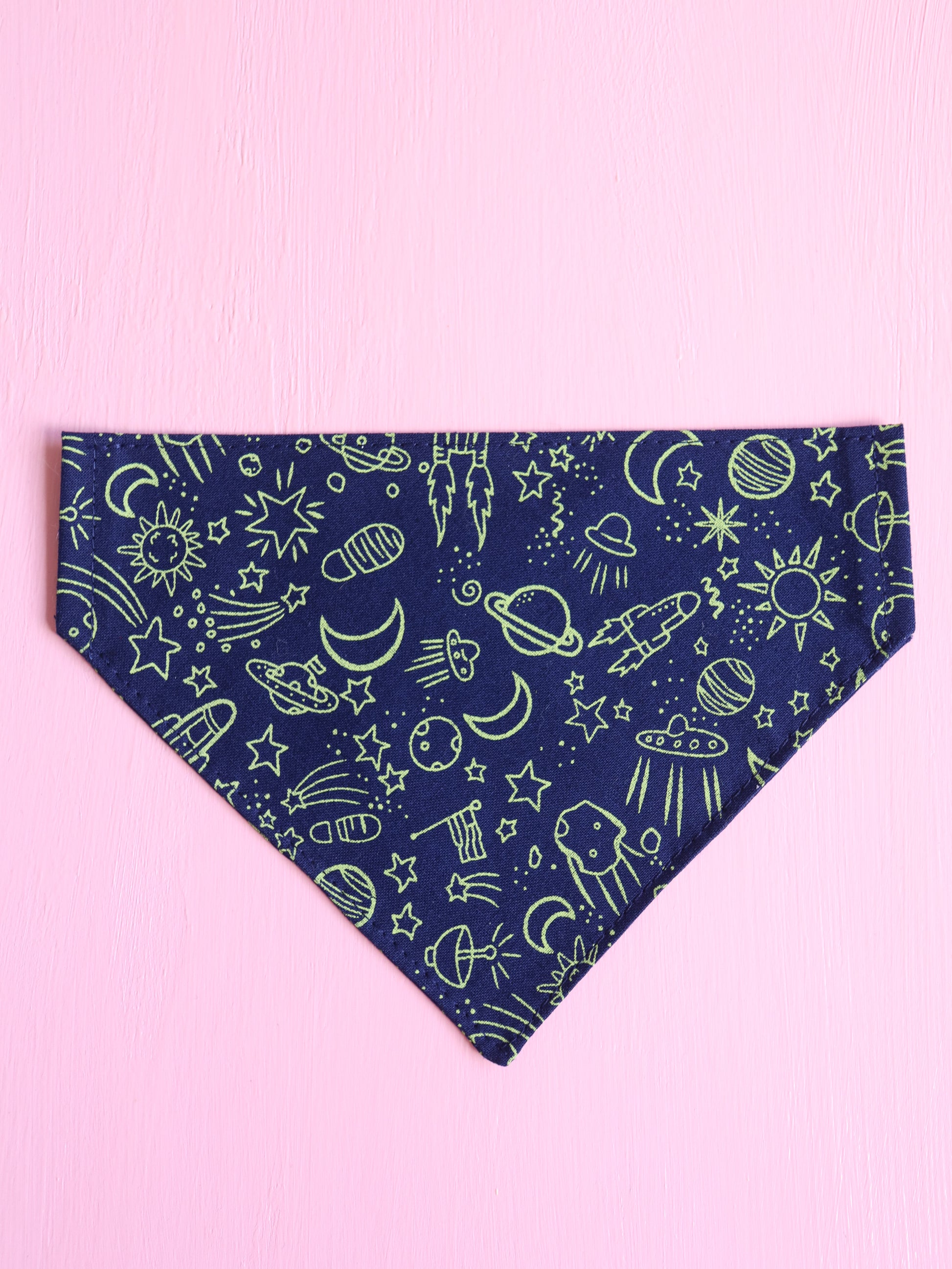 Navy blue bandana with space-themed green patterns on a pink background