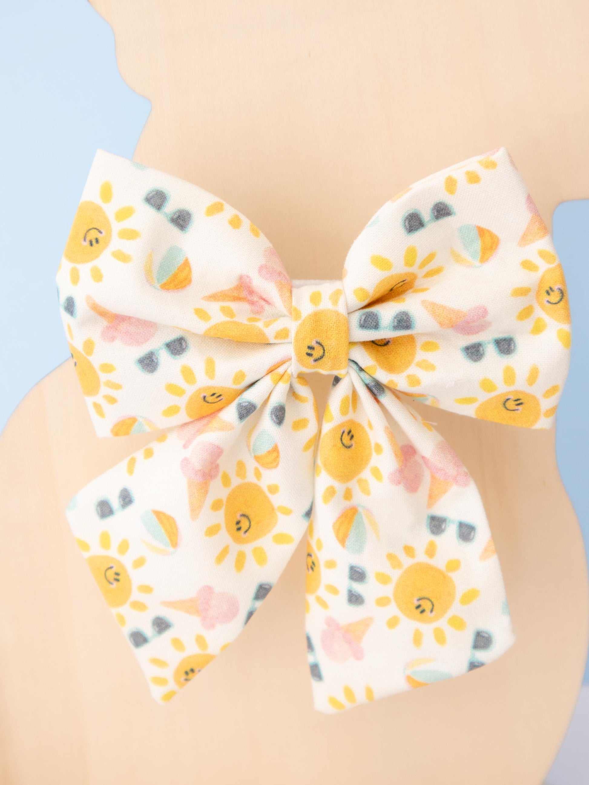 Large bow with sun pattern on a light blue background