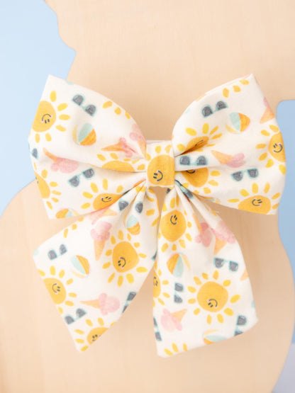 Large bow with sun pattern on a light blue background