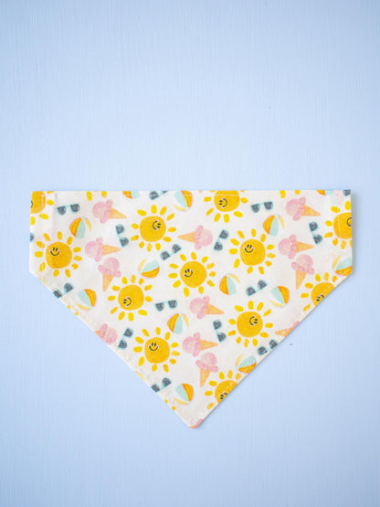 Smiling sun patterned bandana on a light blue background