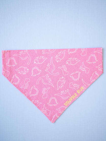 Pink bandana with white dinosaur pattern on a light blue background