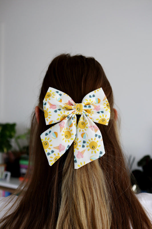 Smiling sun hair bow on a person's head with a blurred indoor background