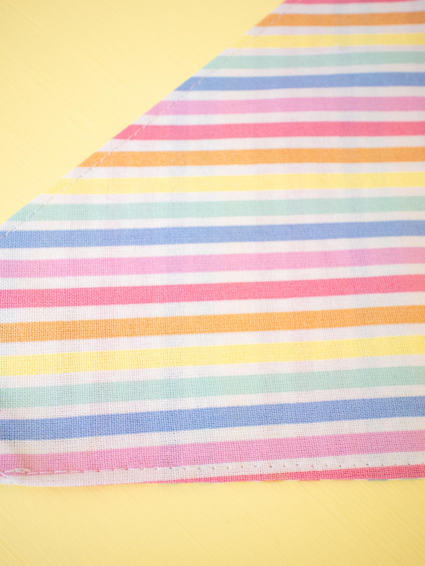 Colorful striped fabric on a yellow background