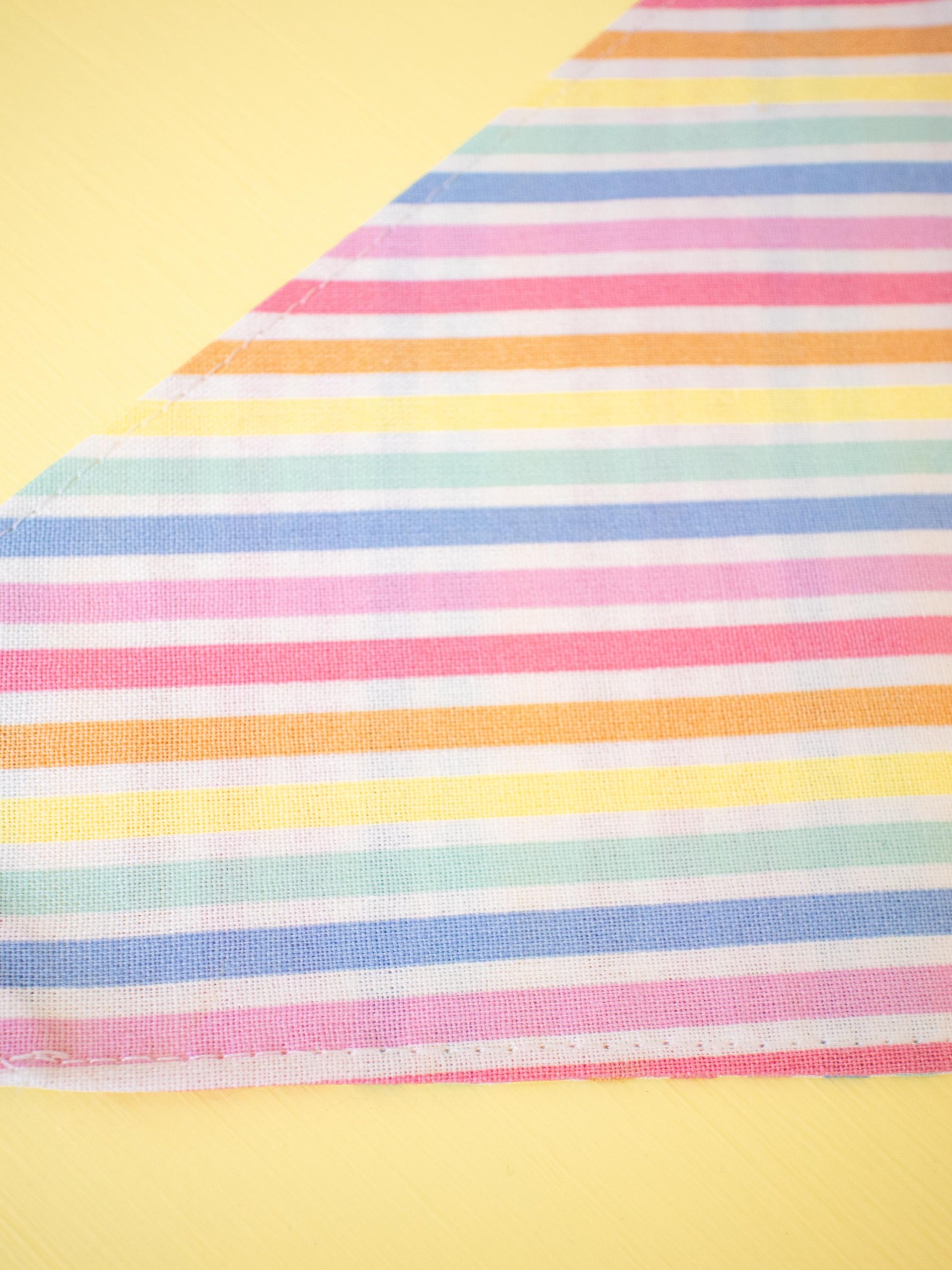 Colorful striped fabric on a yellow background