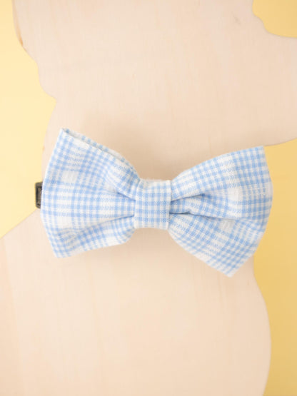 Blue checkered bow tie on a beige background