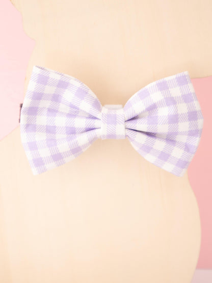 Purple checkered bow on a beige background