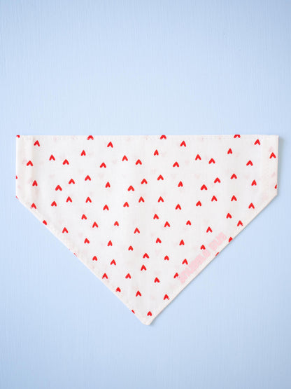 White bandana with red heart pattern on a light blue background