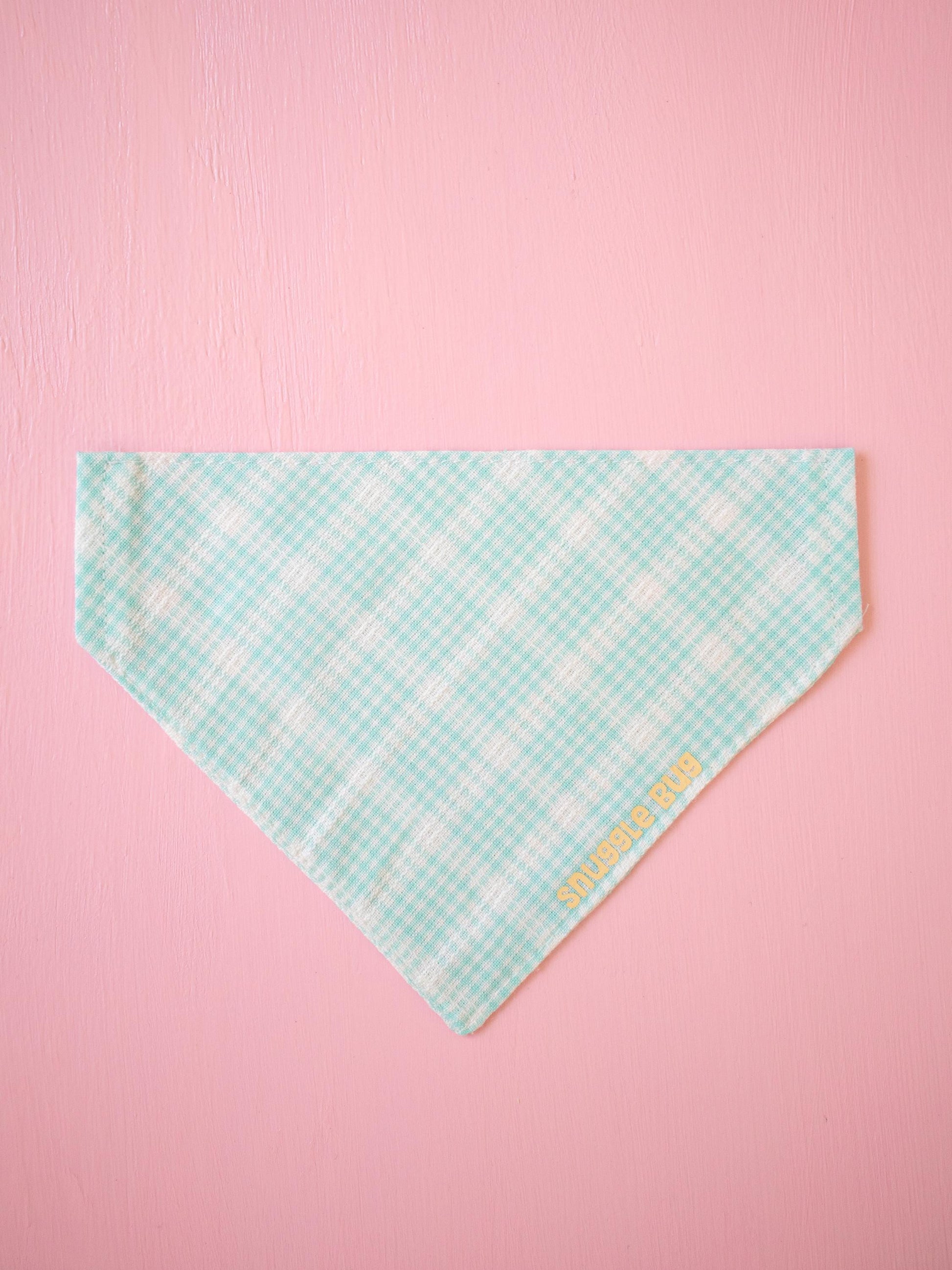 Teal checkered bandana with 'Snuggle bug' text on a pink background