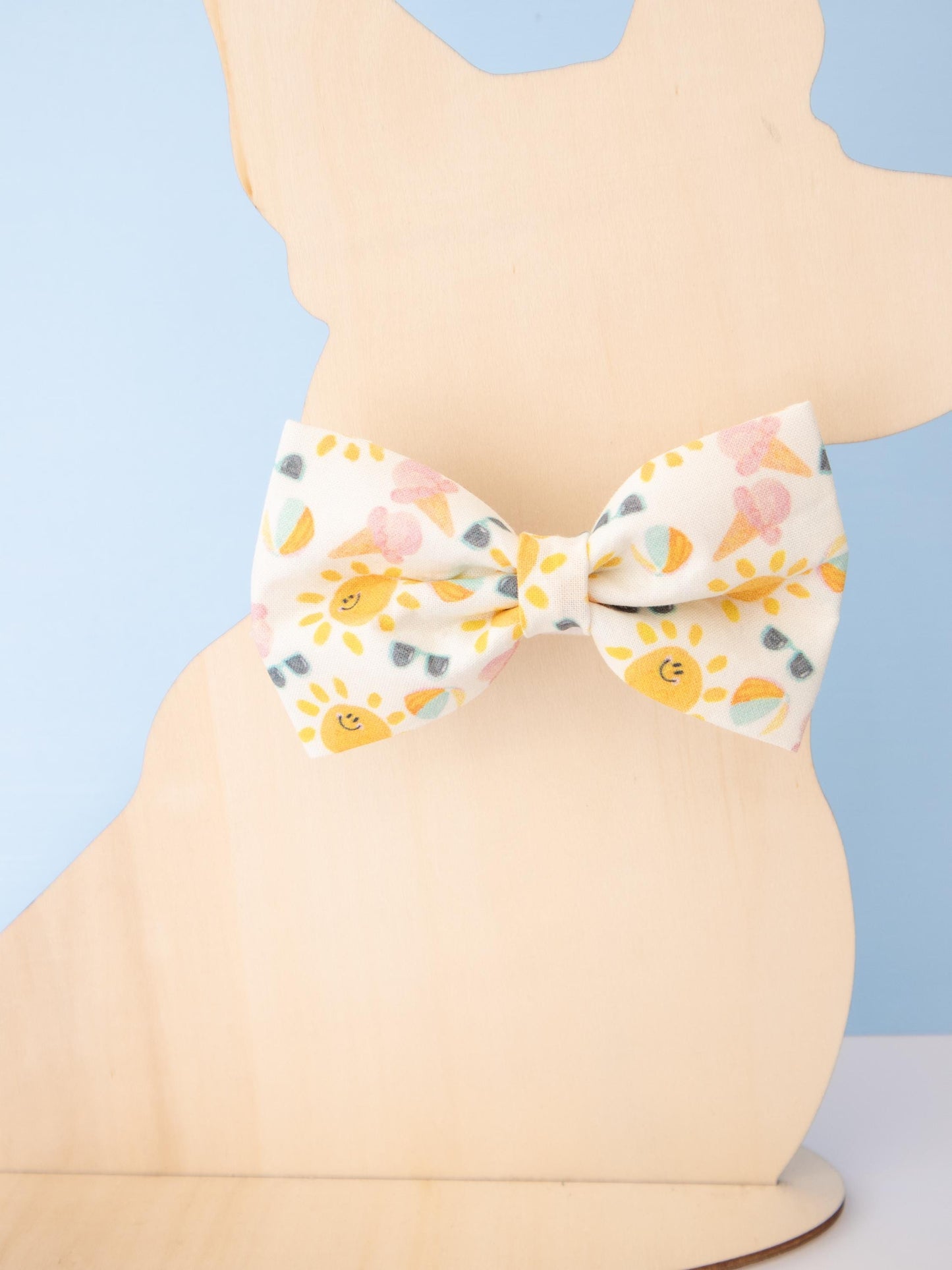 Patterned bow tie on a mannequin against a blue background