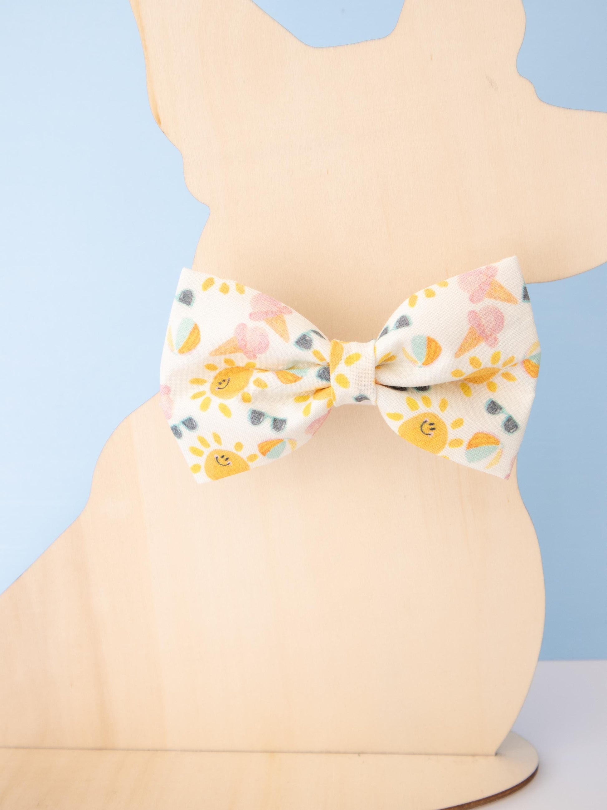 Patterned bow tie on a mannequin against a blue background