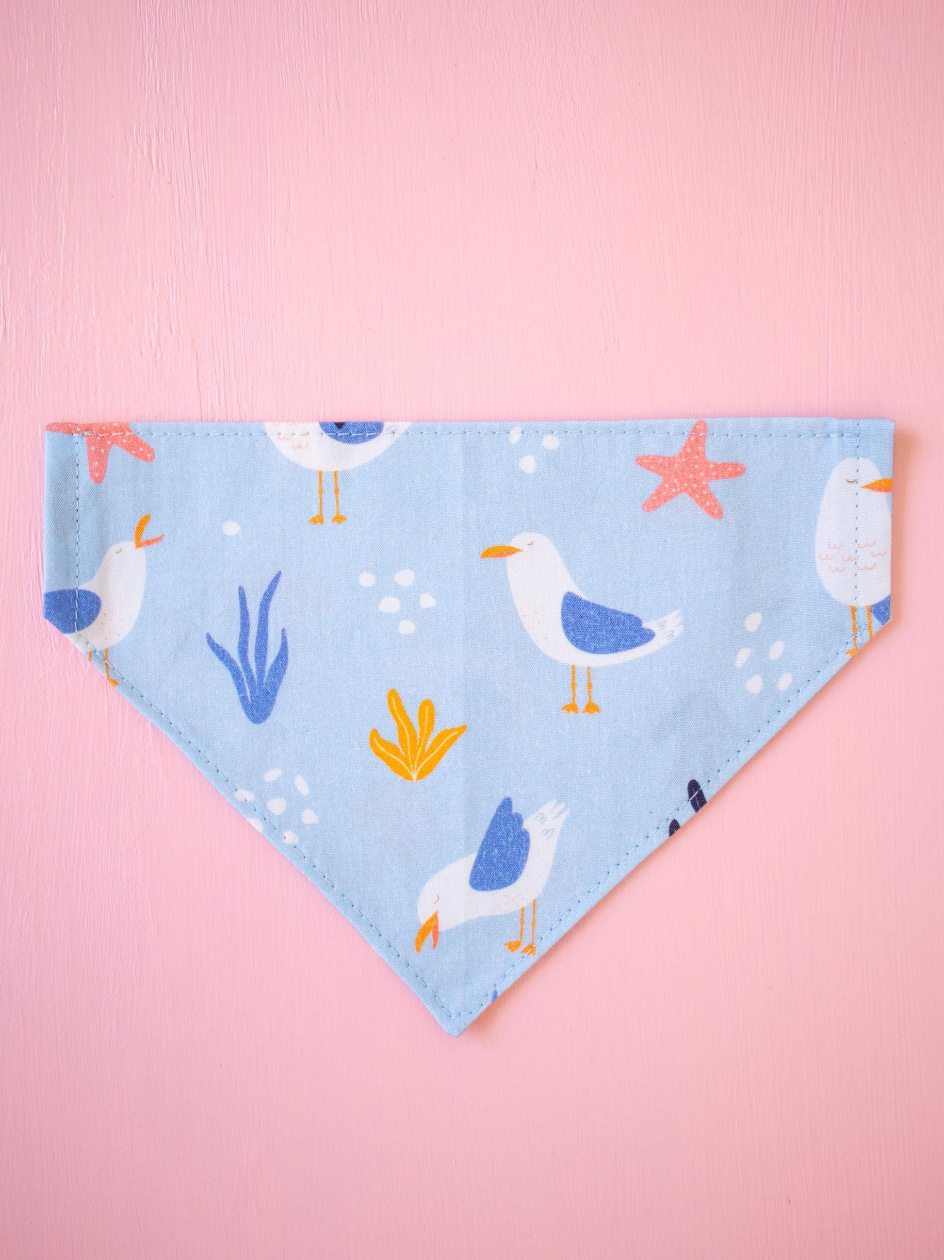 Dog bandana with seagull design on a pink background