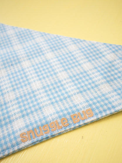 Blue checkered blanket with 'Snuggle Bug' text on a yellow background